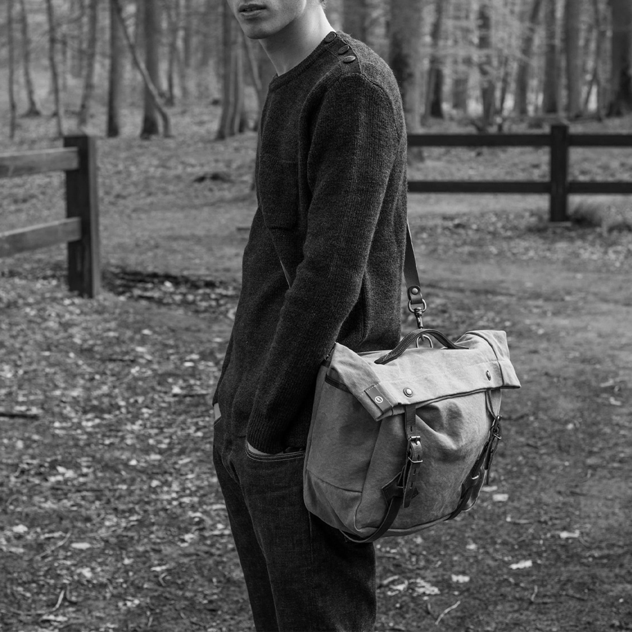 Photo en noir et blanc d'un homme dans la foret, il porte une musette &agrave; l'&eacute;paule
