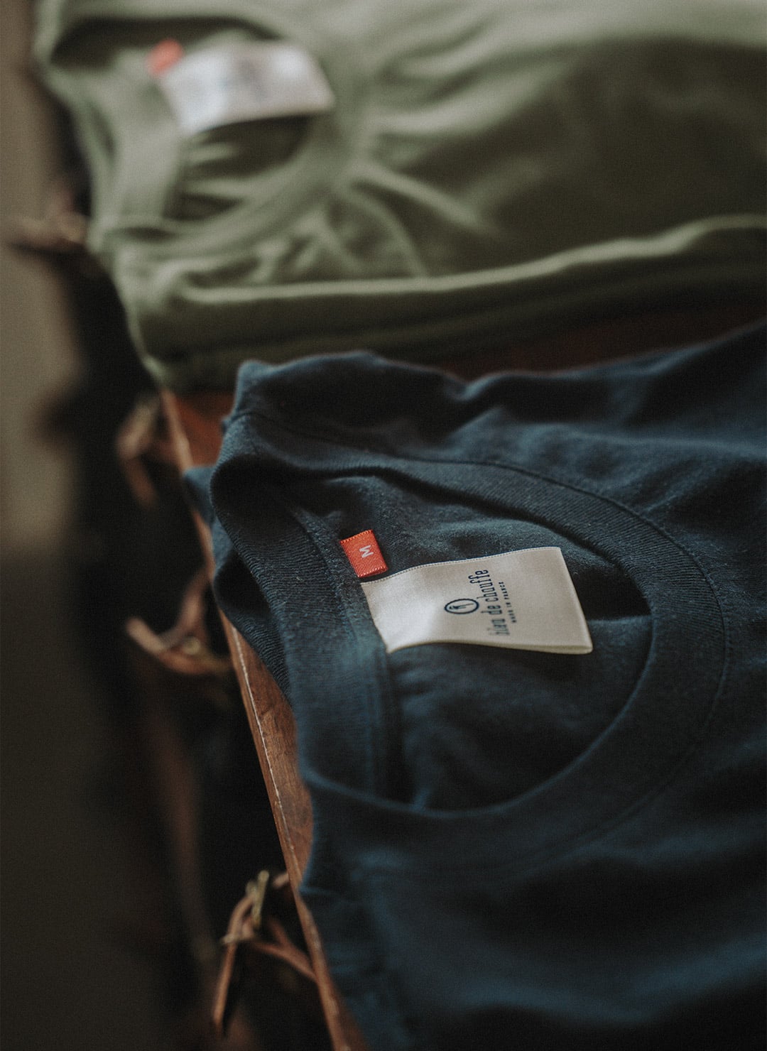 Organic men's t-shirt folded on a wooden cart