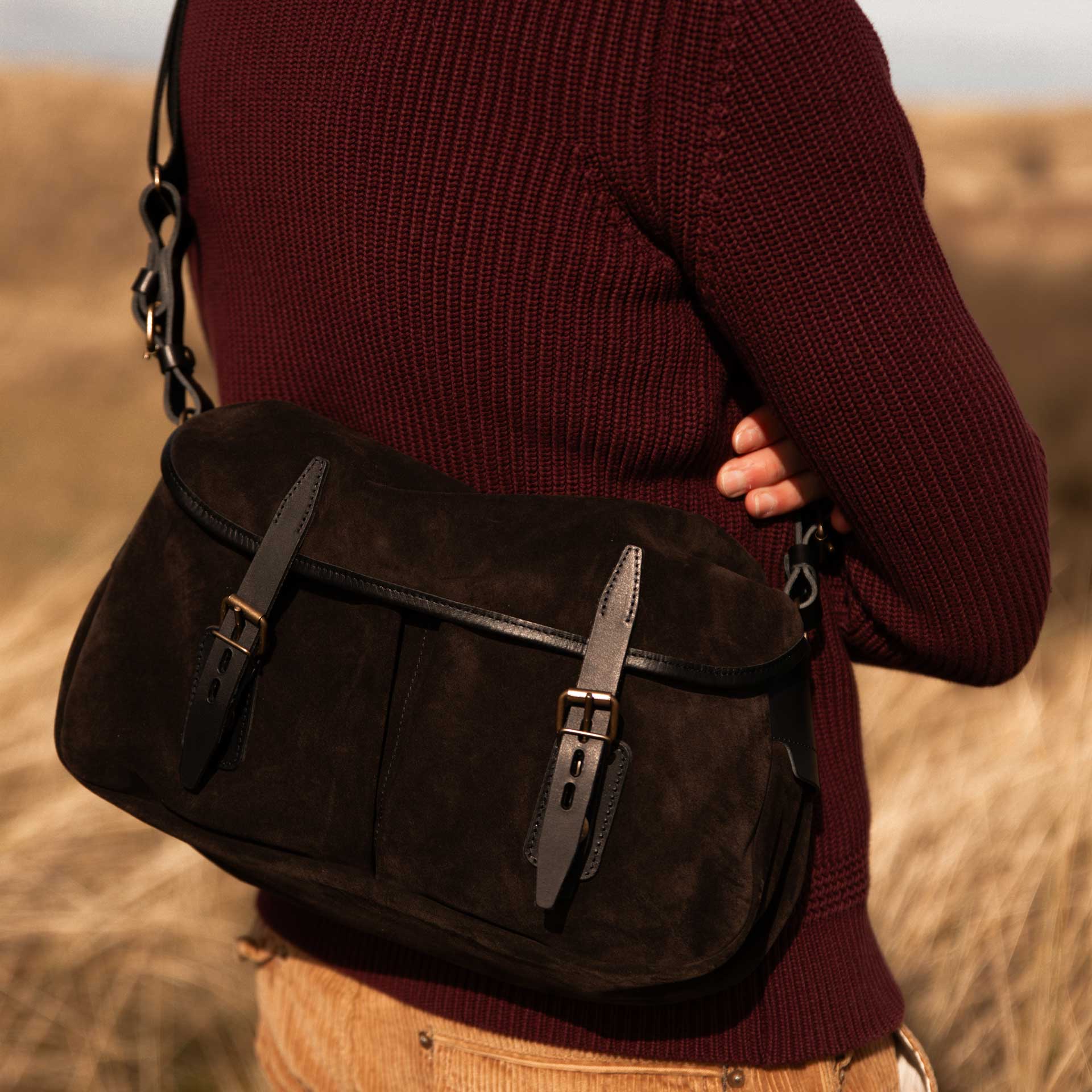 Close-up of a man carrying his leather shoulder bag