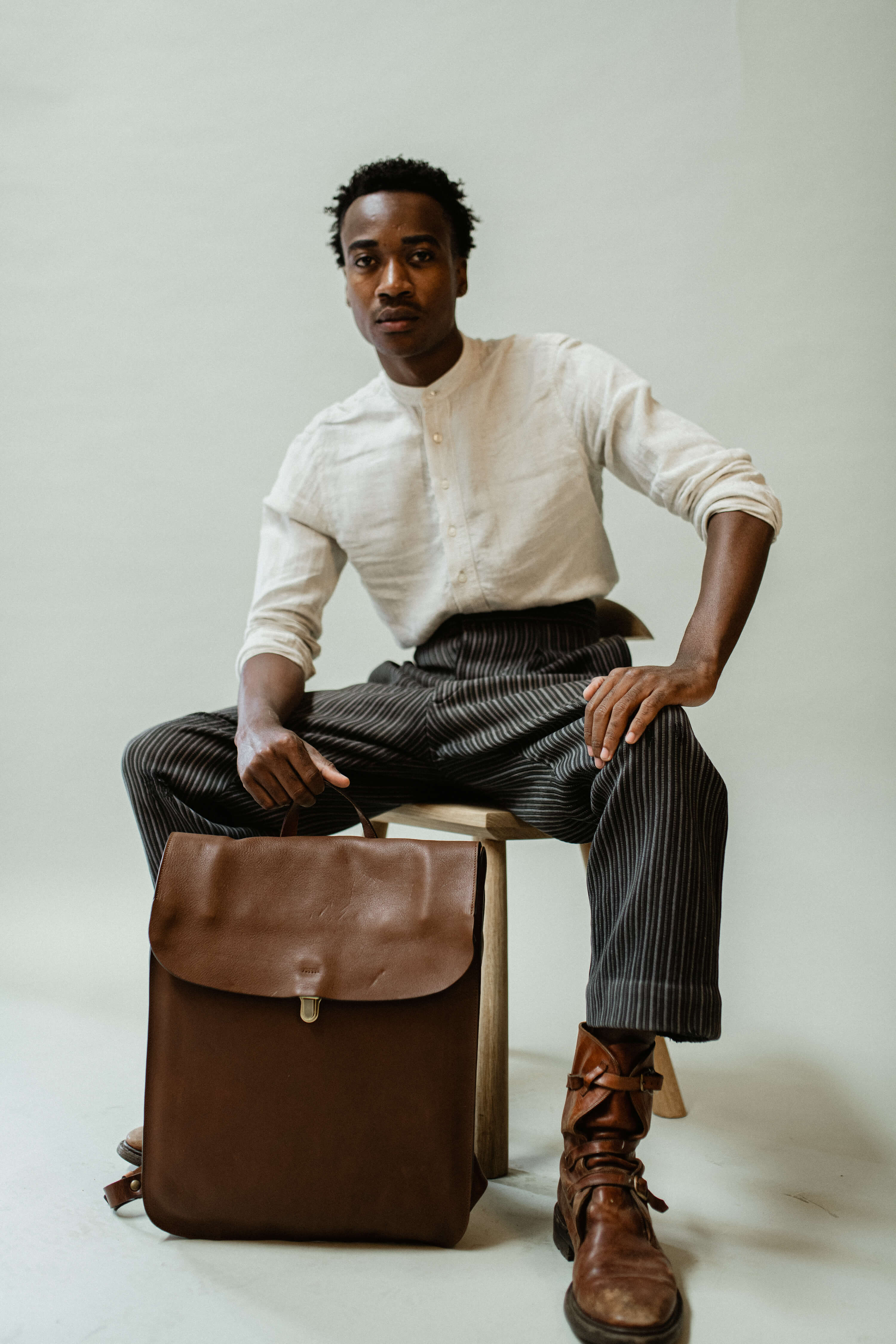 A man carrying a leather backpack