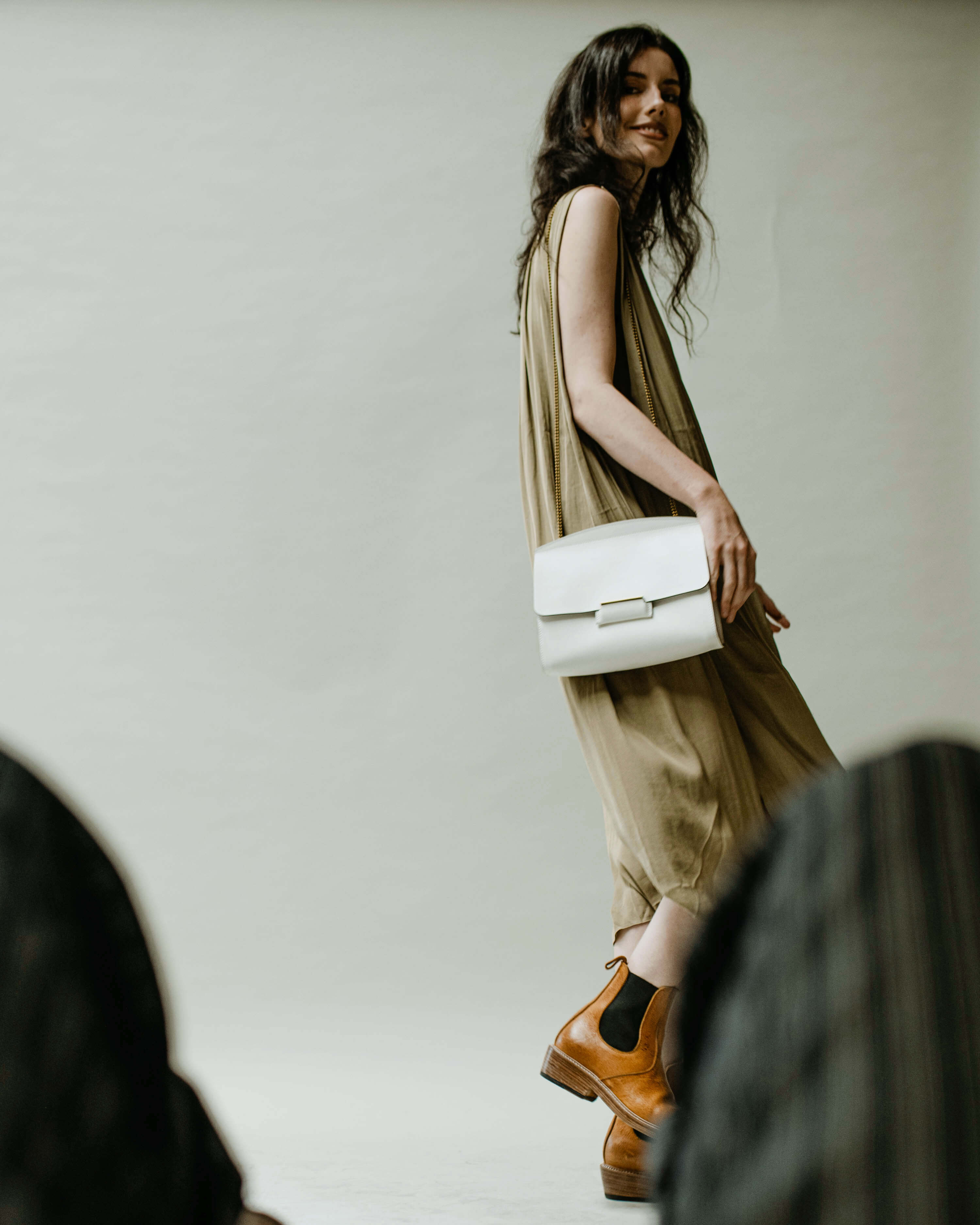 A woman carrying a leather handbag